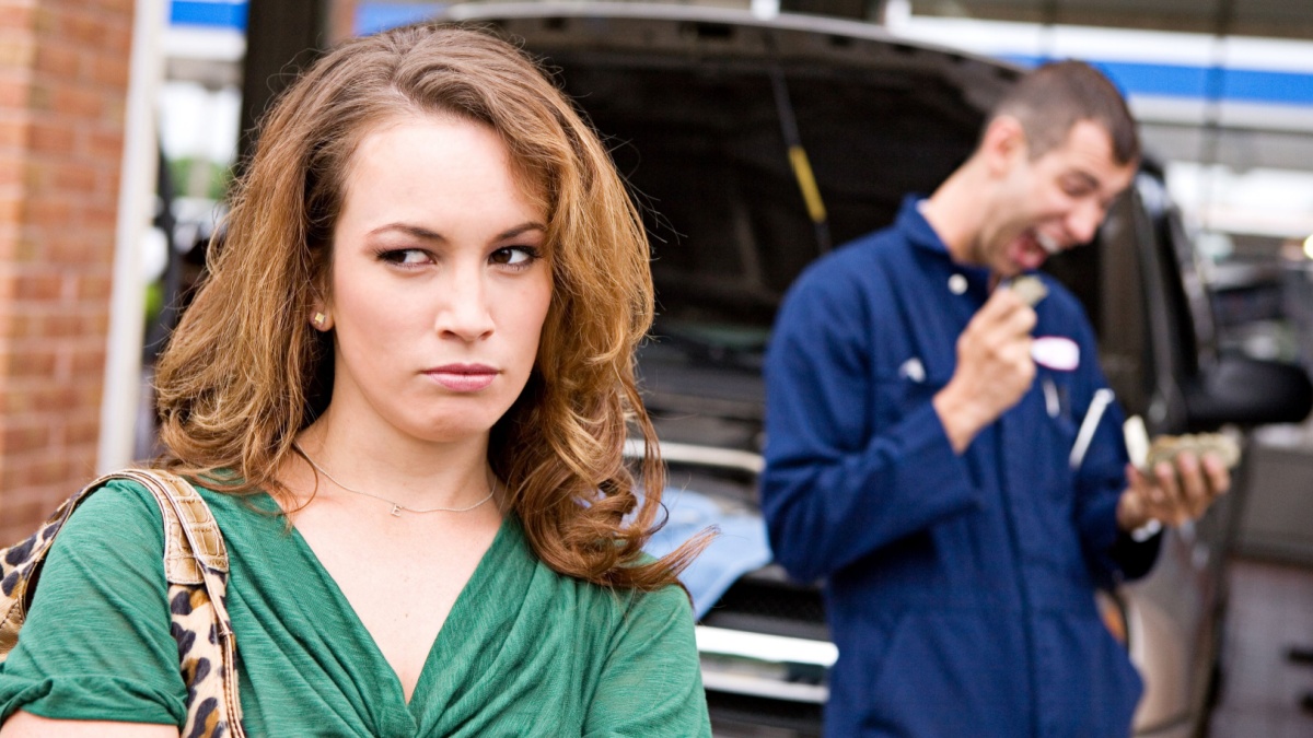 Mechanic: Upset Customer With Rip Off Mechanic In Background.