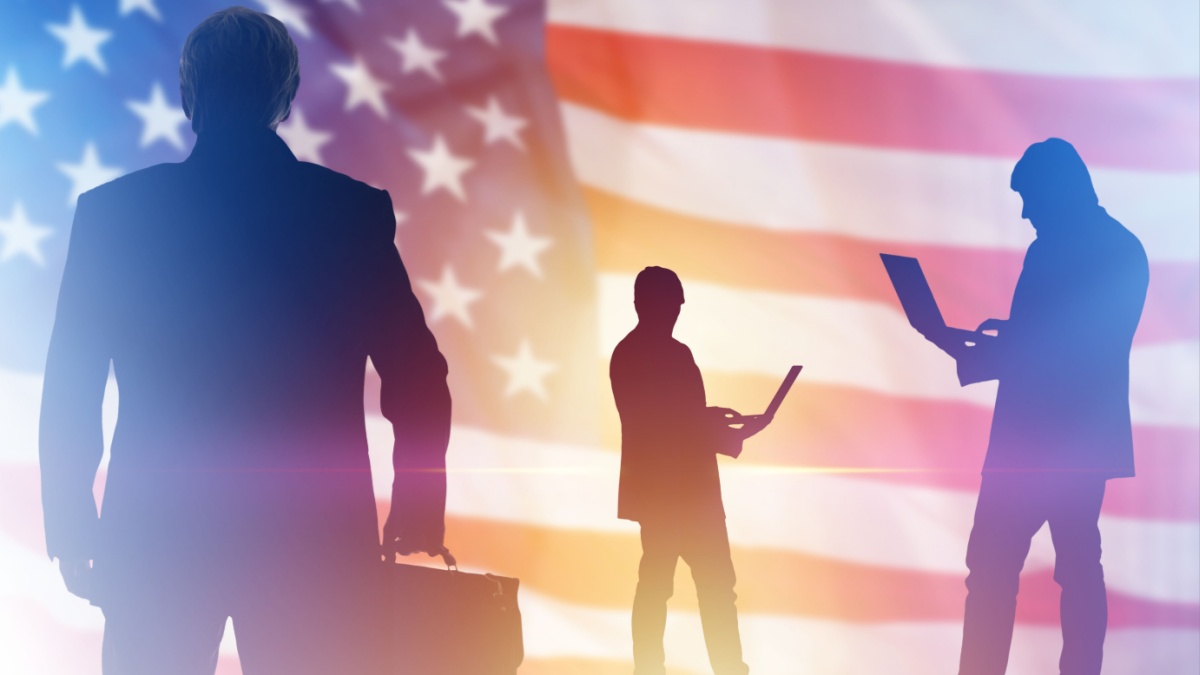 Silhouettes of a man on background of American flag. Concept lobbying for business in USA. Lobbyists with laptops. Lobbying Interests in USA. Promotion of interests in political community USA.