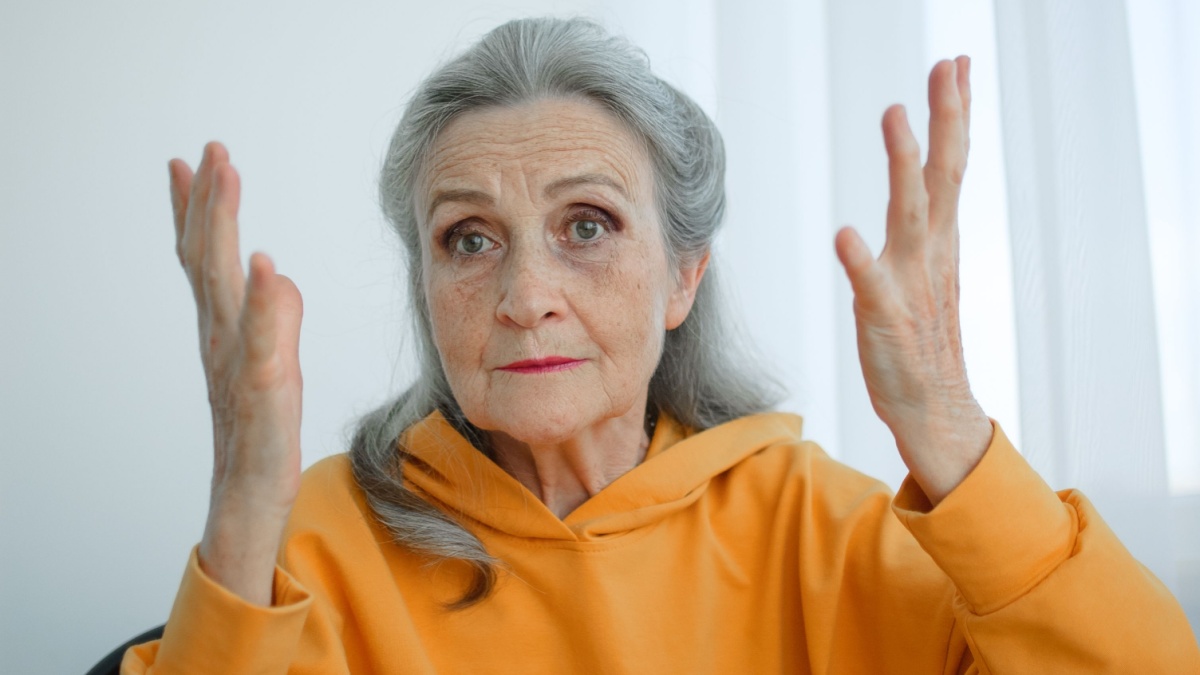 Closeup portrait of angry upset senior mature woman talking with someone and looking at the camera. Negative emotion, facial expression, scandal.