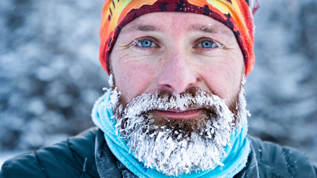 portrait of man face with frozen beard in harsh winter.