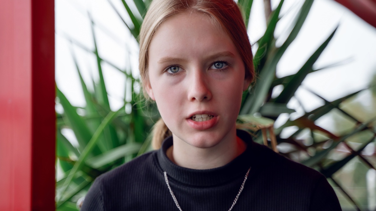 angry teen blong girl talks viciously with hate. Problem concept.