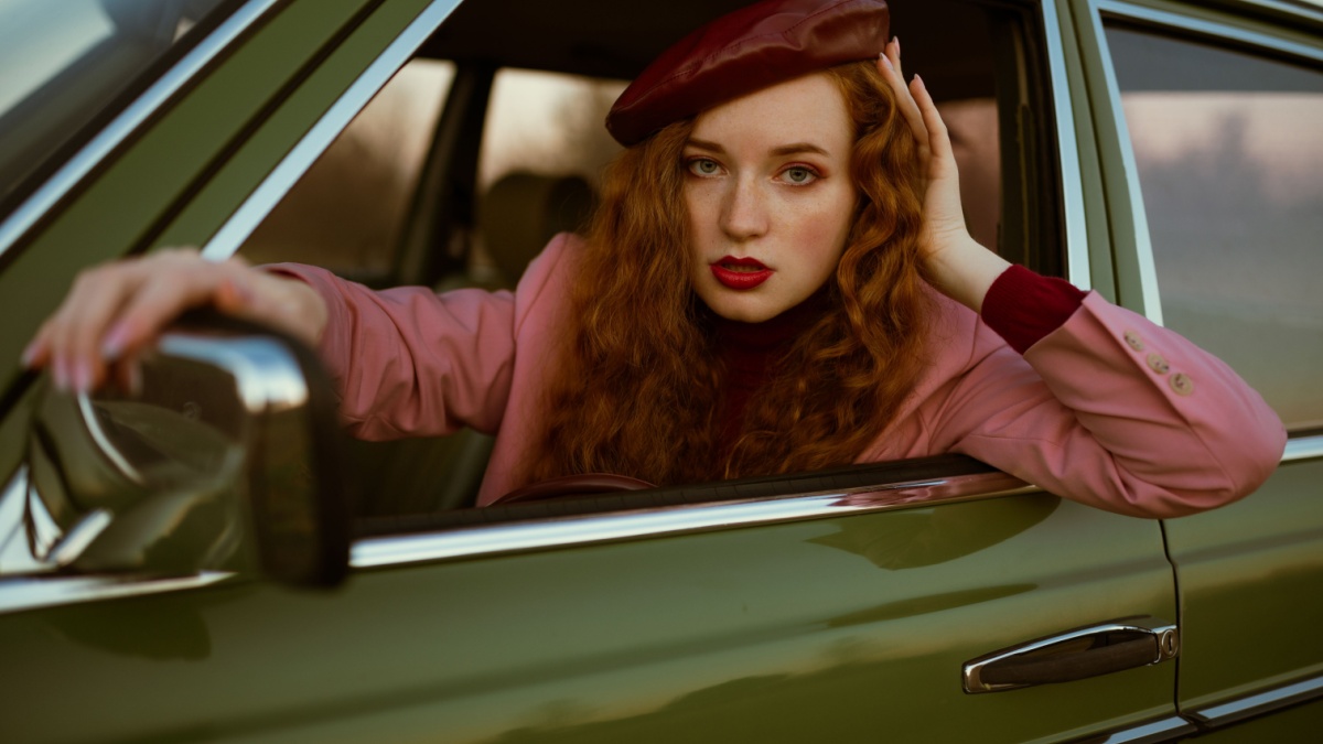 Fashionable elegant confident redhead woman with marsala color lips, eyes makeup, wearing faux leather beret, classic pink blazer.