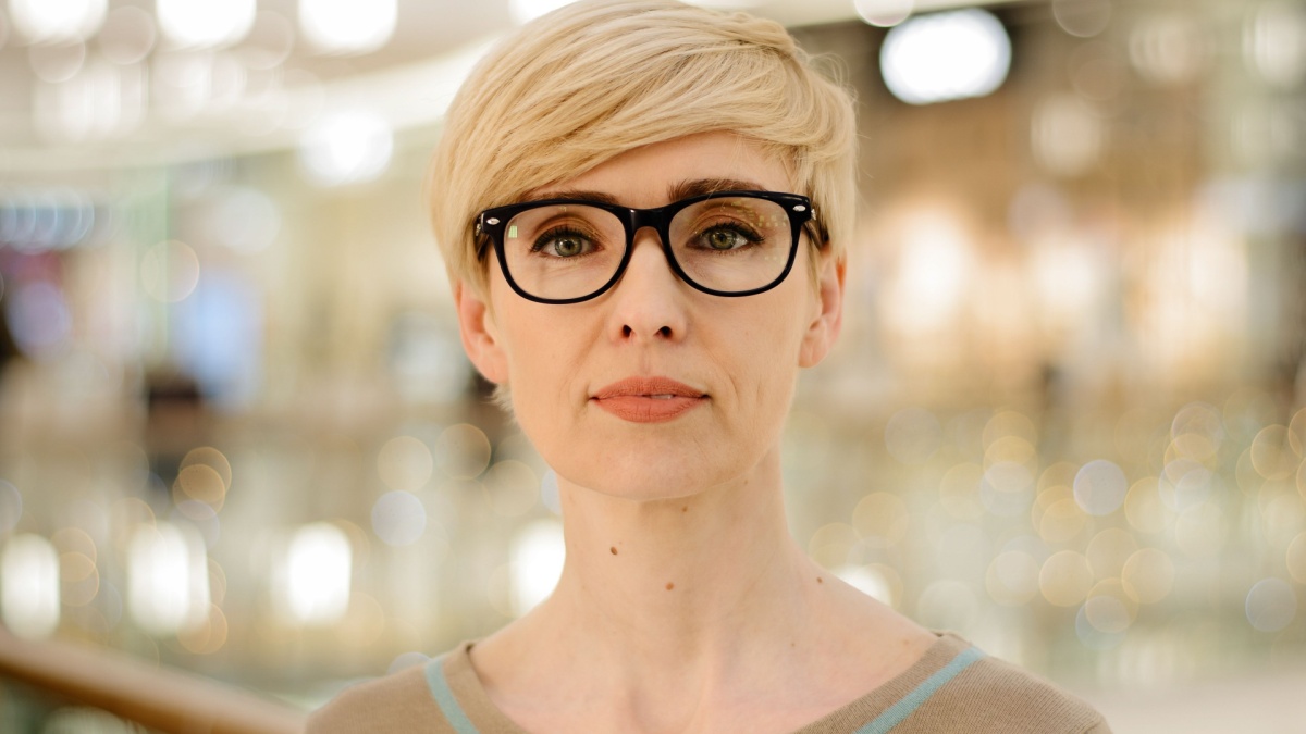 Close-up middle-aged adult lady in glasses looking at camera poor vision problems with eyesight.