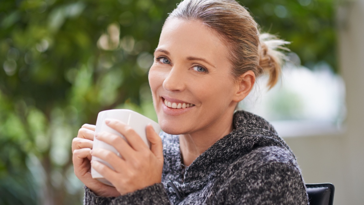 Happiness is only a sip away. Shot of an attractive mature woman enjoying a hot drink at a spa.