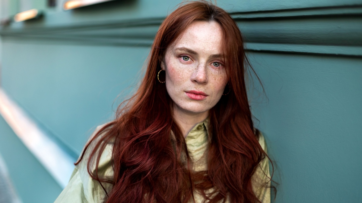 Woman freckled face close up. Young girl outdoor portrait.