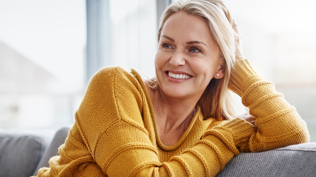Relaxing really lifts the spirits. Shot of an attractive mature woman relaxing on the sofa at home.