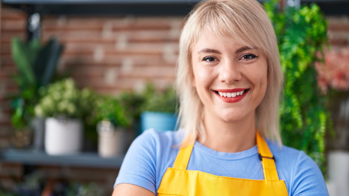 Young blonde woman florist smiling confident standing at florist.
