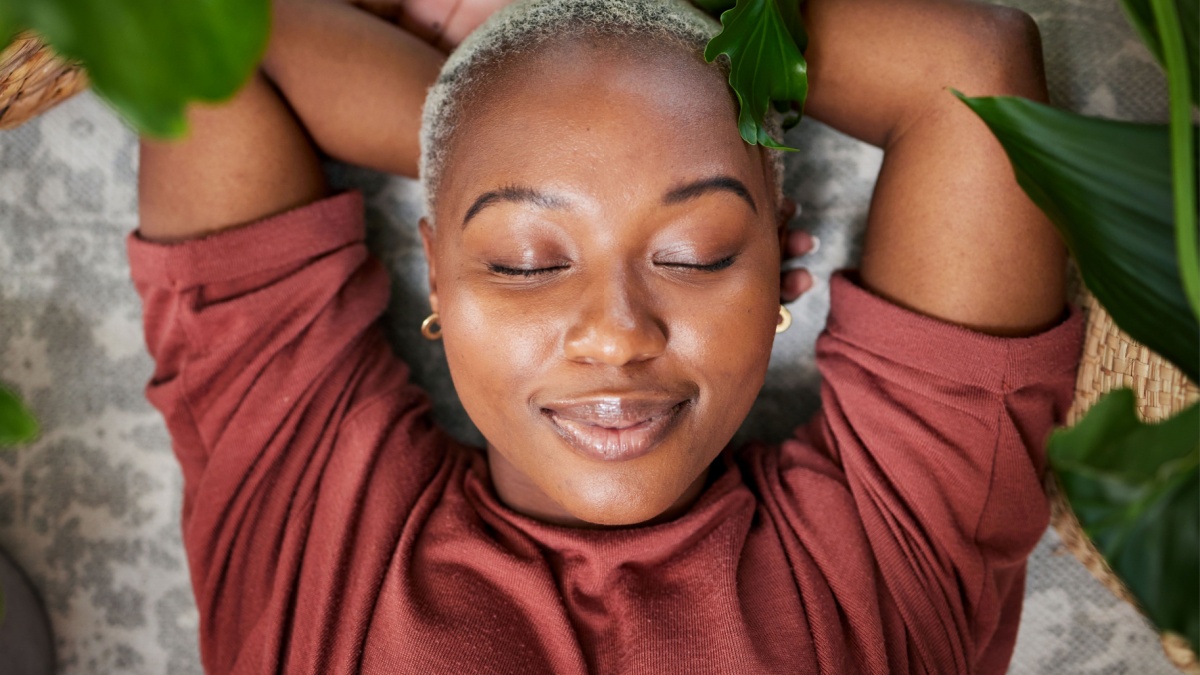 Relax, plants and above of black woman in home for wellness, zen mindset and calm energy.