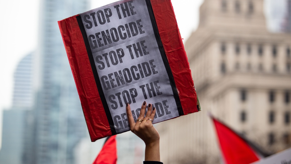 Person holds up a sign saying Stop the Genocide at a Palestinian demonstration Toronto Canada against the war in Gaza
