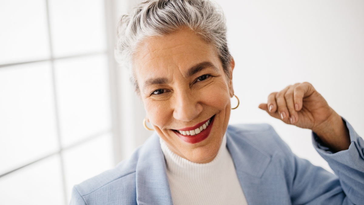 Portrait of a senior woman with grey hair wearing a business suit at work. Experienced business woman smiling in her office, confident and self-assured in her capabilities as a top professional.