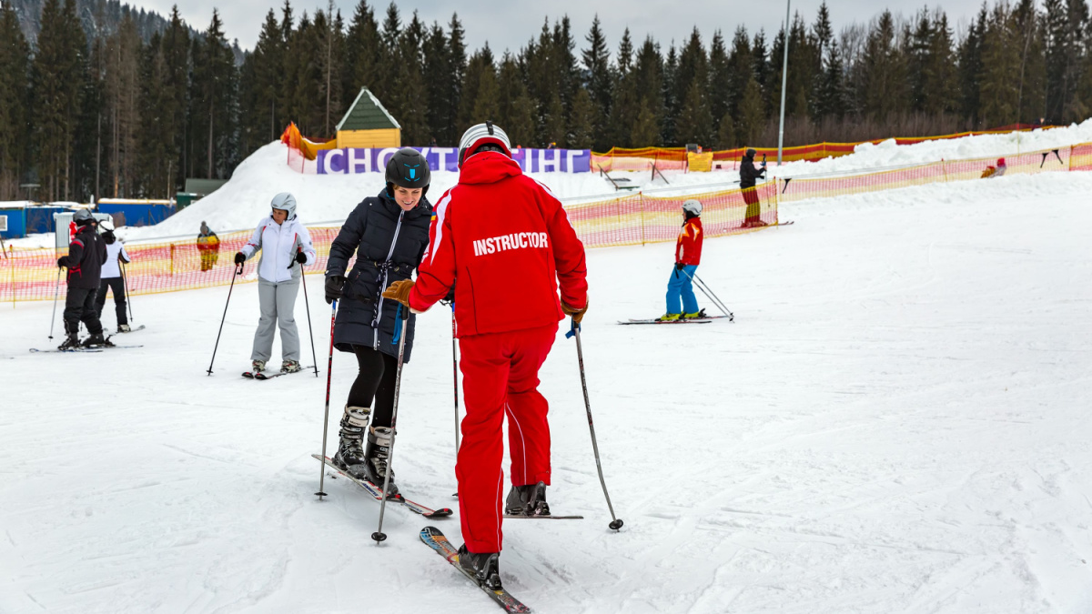 ski instructor trains a woman to ride.Mountains ski resort