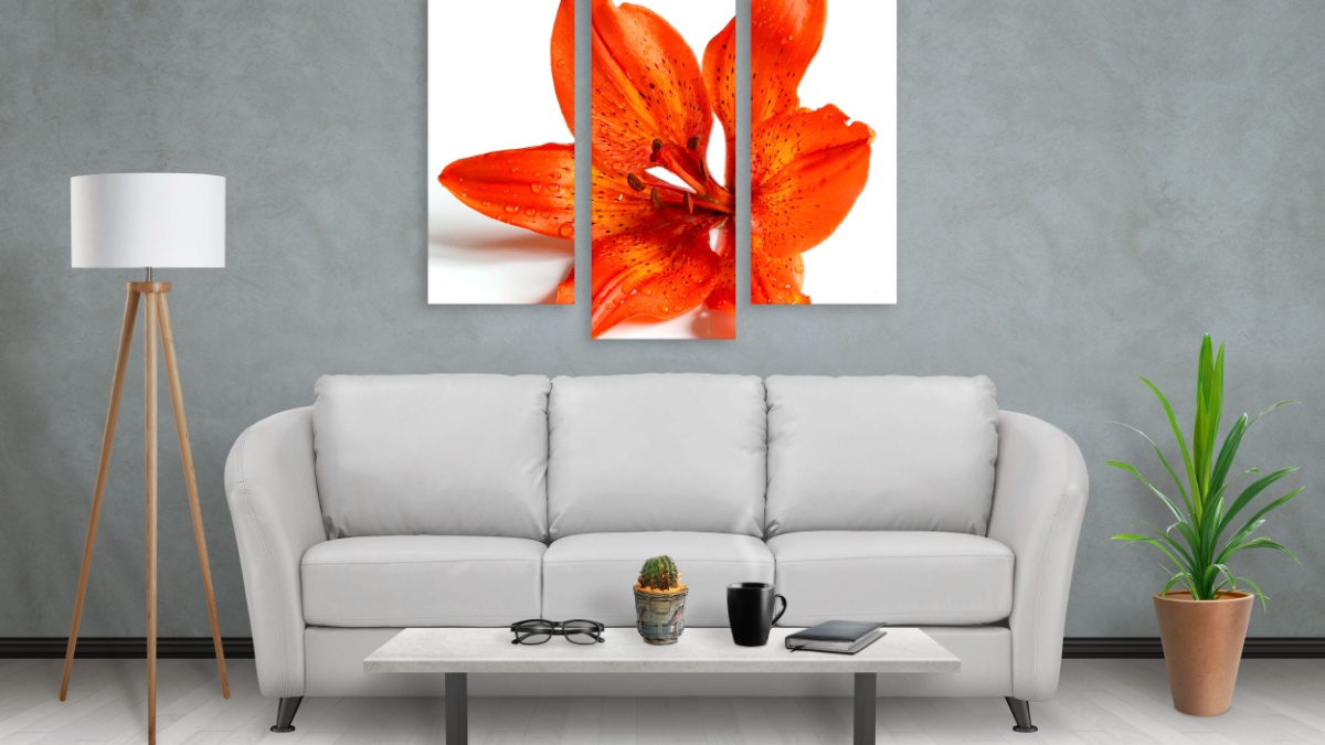 Flower on wall art canvas in three parts. Sofa, lamp, plant and table in room interior.
