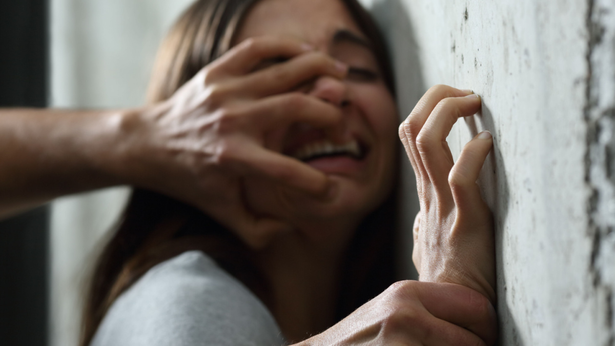 Sexual abuse with a man attacking to a scared woman in a dark place