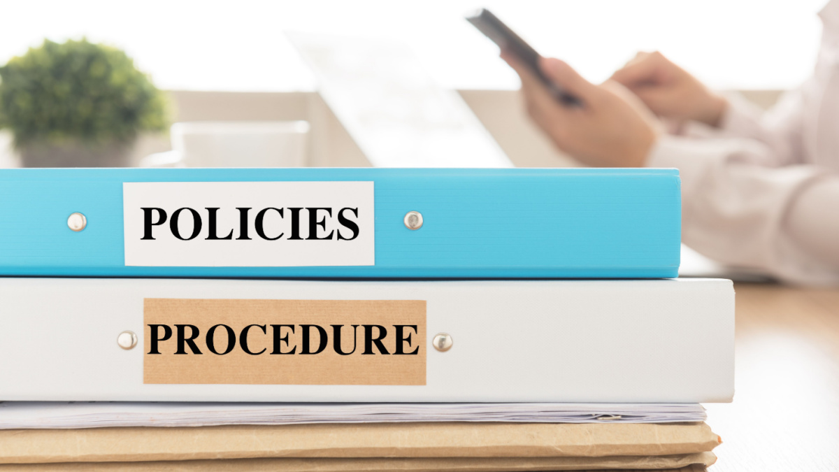 Policies and Procedures doucument place on desk in meeting room. Policy, Procedure concept.
