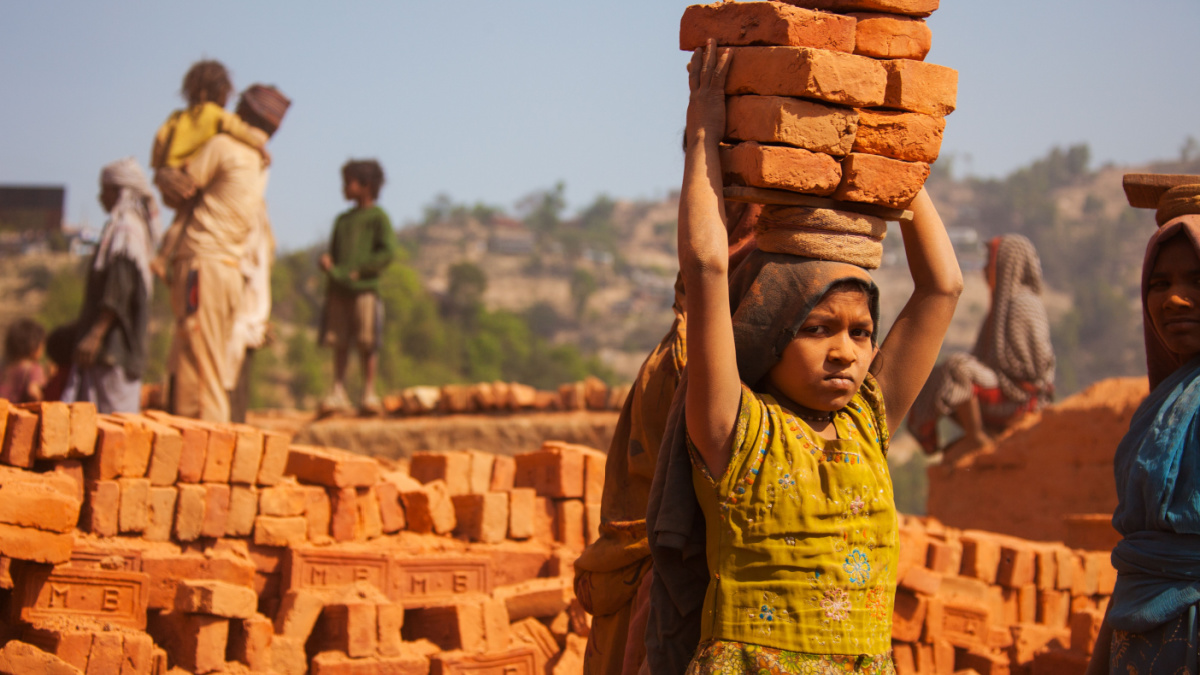 A young girl working in a brick factory