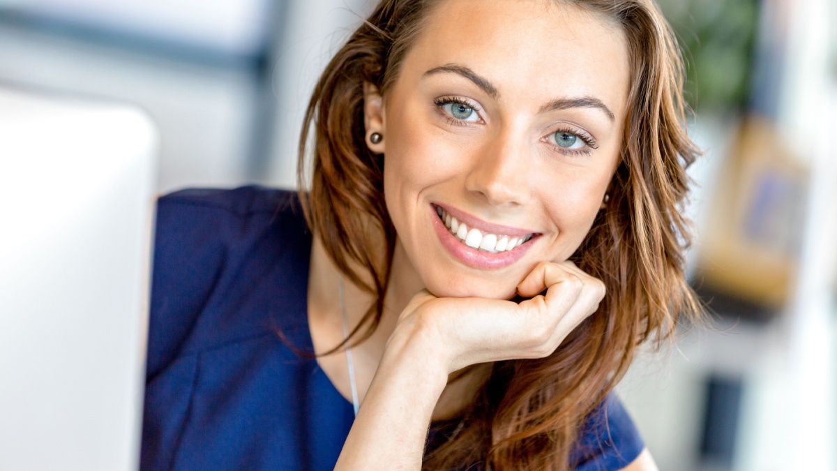 Portrait of businesswoman working at her desk in office.