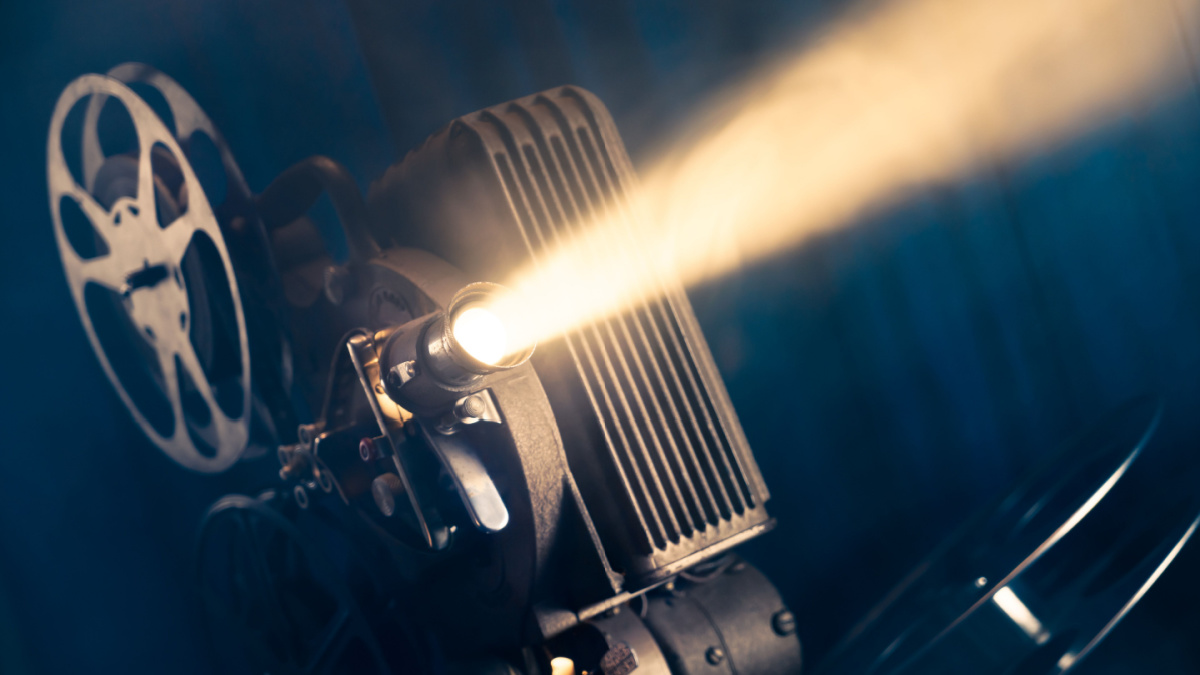 film projector on a wooden background with dramatic lighting and selective focus