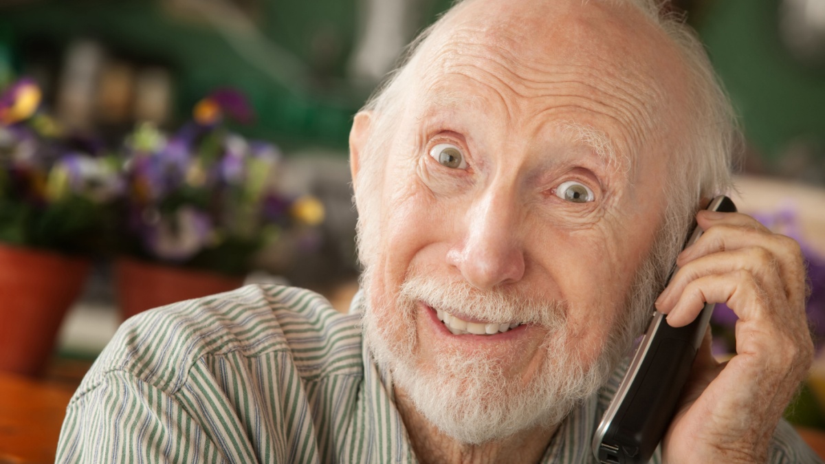 Senior man at home on the telephone.