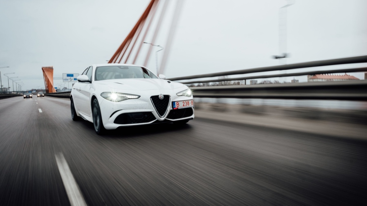 Riga, March 17, 2017 - White Alfa Romeo Giulia Quadrifoglio is driven at high speed on streets of Riga.
