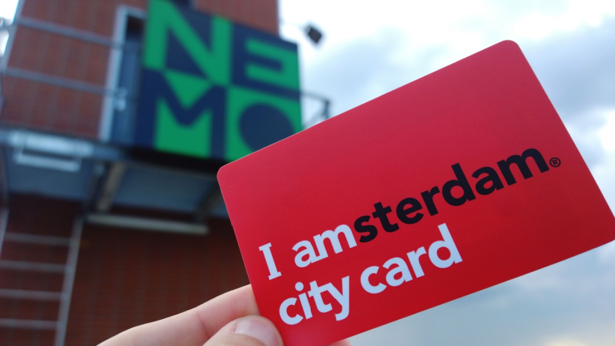 Female hand holding a red tourist guest card