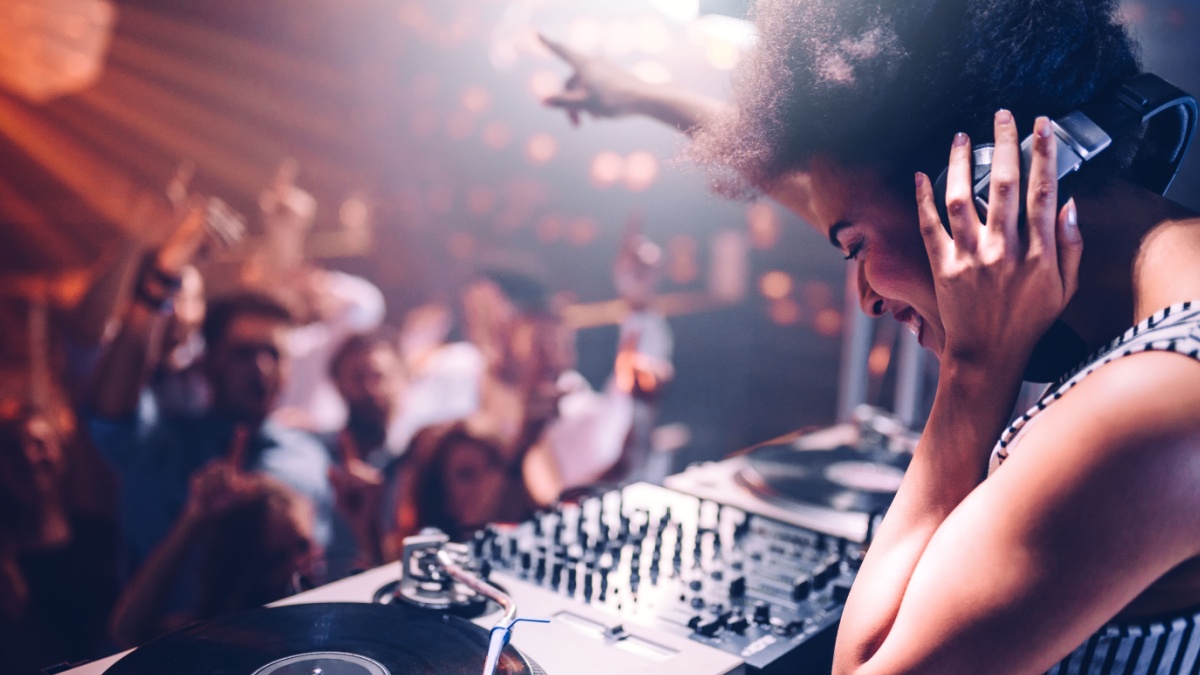 Young woman playing music at the club