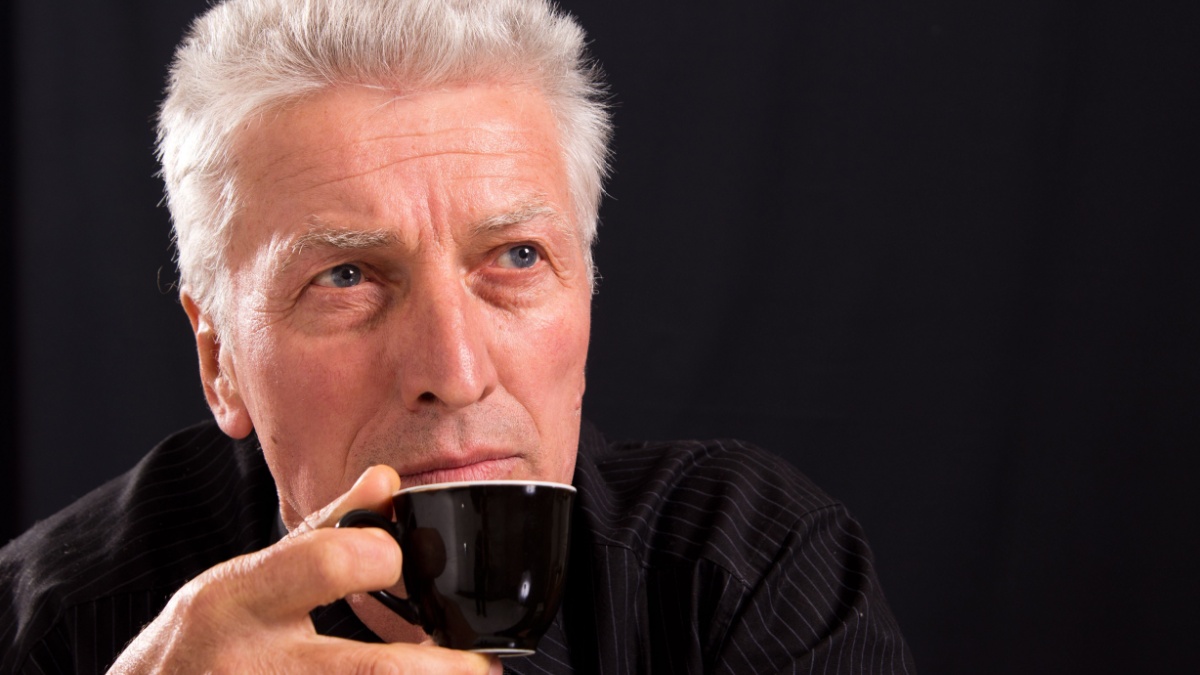 portrait of a cute old man on a black.