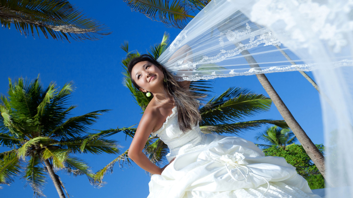 Beautiful asian bride posing at an exotic location.