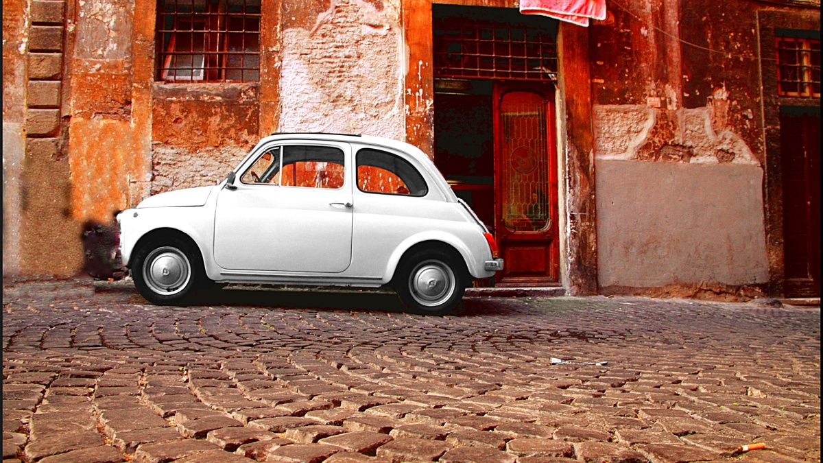 ROME - SEPTEMBER 13: A Fiat 500 on September 13, 2011 in Rome. Launched as the Nuova (new) 500 in July 1957, it was marketed as a cheap and practical town car. It soon become an Italian symbol.
