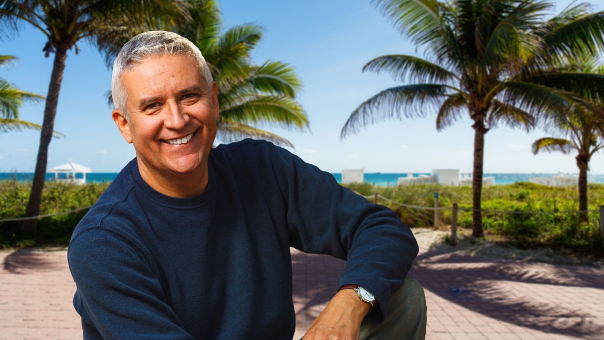 Handsome middle age man outdoor portrait with a Miami Beach background.