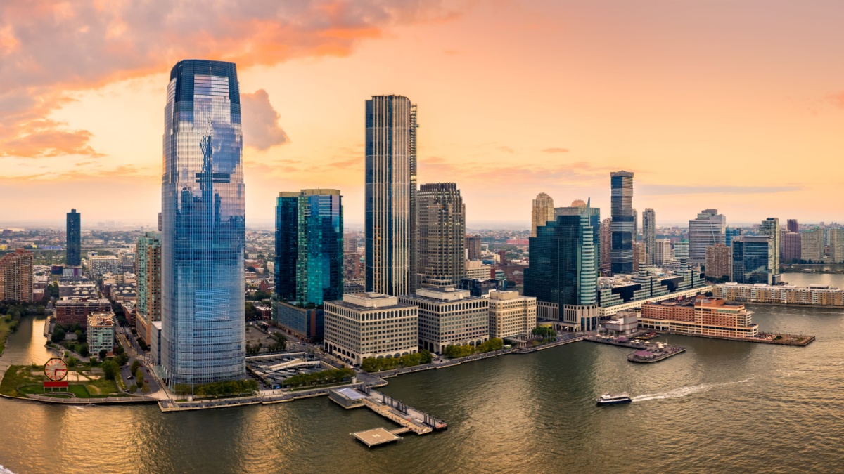Aerial panorama of Jersey City skyline at sunset.