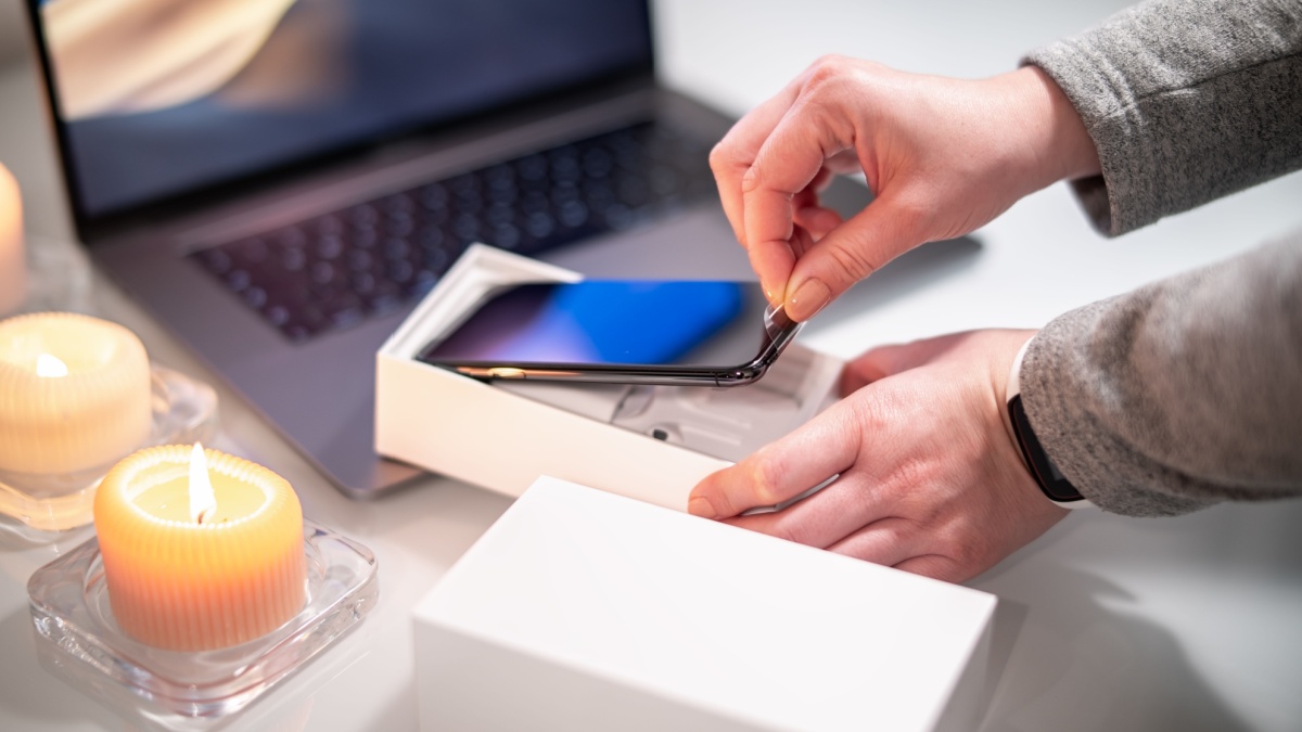 Woman unpacks a new smartphone.