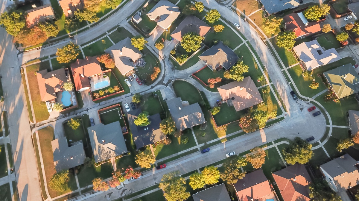 Top view residential neighborhood with cul-de-sac (dead-end) in Carrollton, Texas, USA in autumn sunset. Row of tightly packaged home with swimming pool, garden, driveway and attached garage
