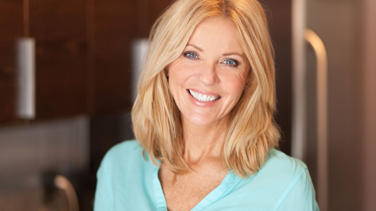 Portrait of a mature woman smiling at the camera. She is confident and proud.