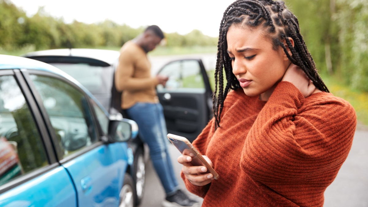 Female Motorist Involved In Car Accident Calling Insurance Company Or Recovery Service.