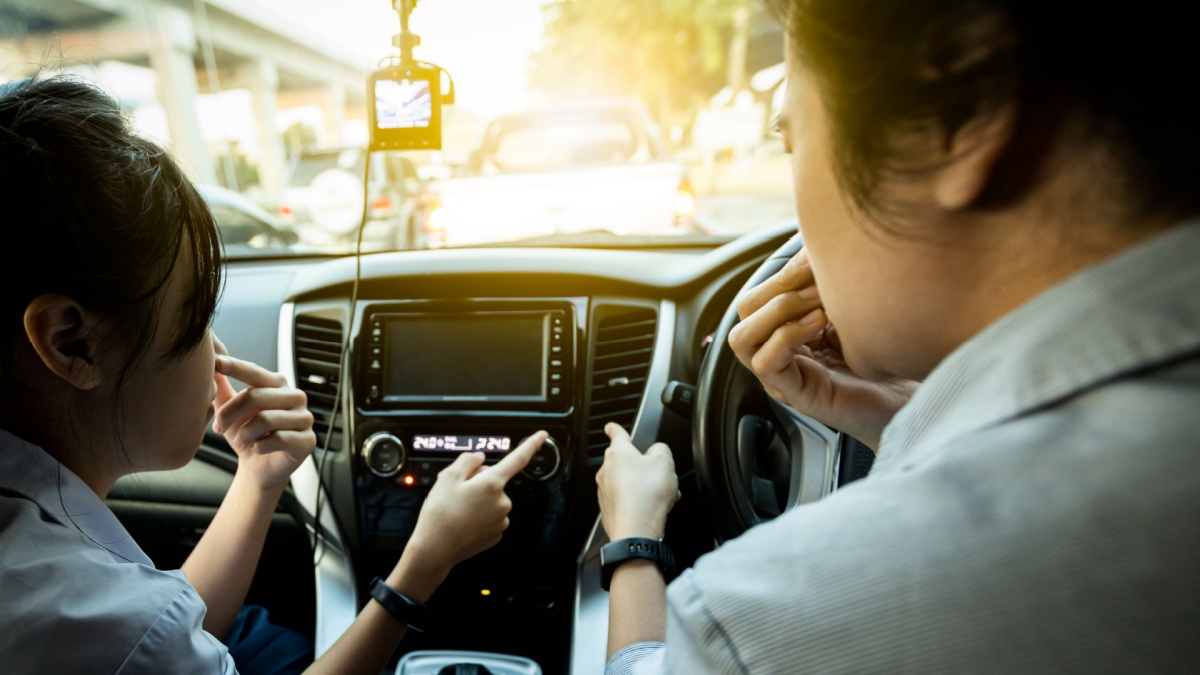 Asian mother and daughter are closing her nose, bad smell, smell of car smoke or dust and dirt coming in through the air ventilation, air conditioner has a problem, concept for checking car condition