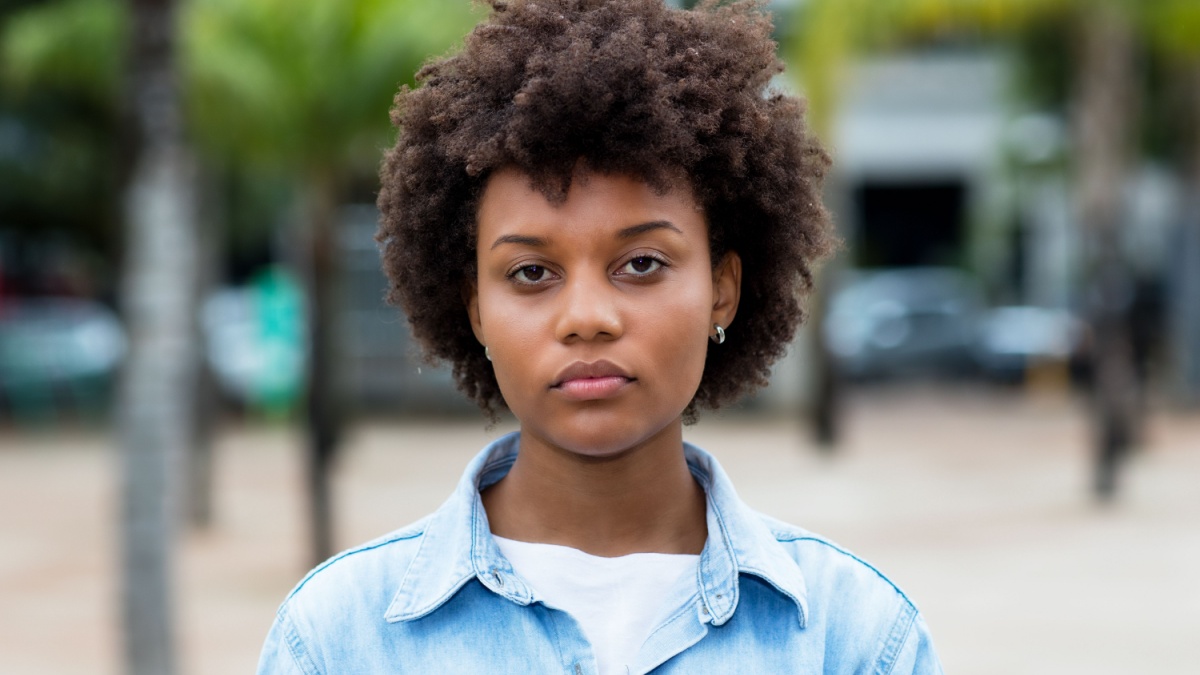 Serious black woman from Brazil in city.