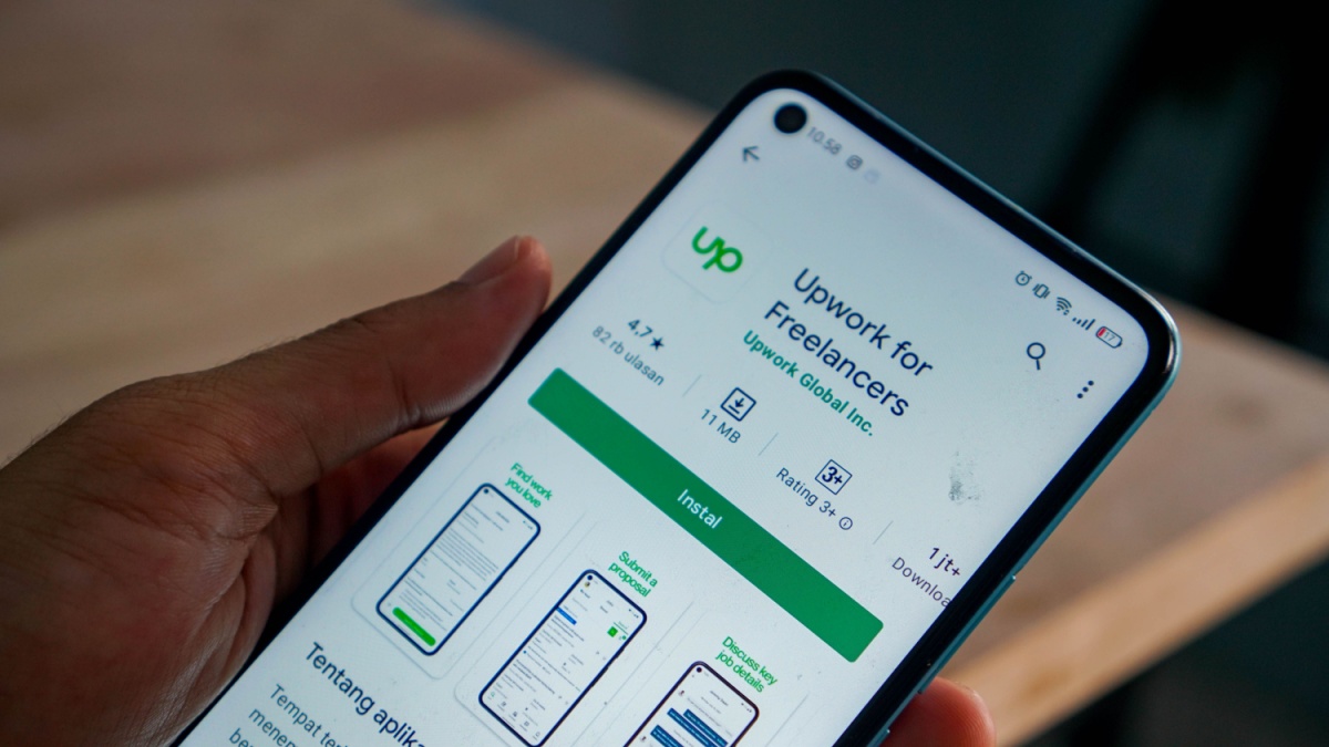 Upwork app on android. hand holding smartphone opens upwork app. freelance app 