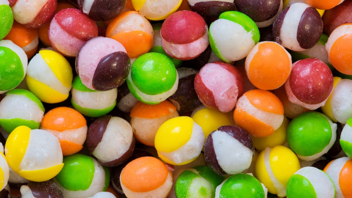 Freeze dried Skittles hard candy with splits through their centers. Colorful sweet food background.