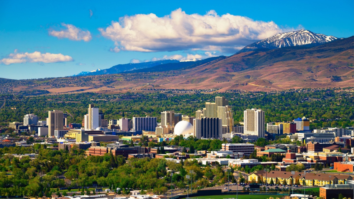 Downtown Reno skyline, Nevada, with hotels, casinos and the surrounding High Eastern Sierra foothills