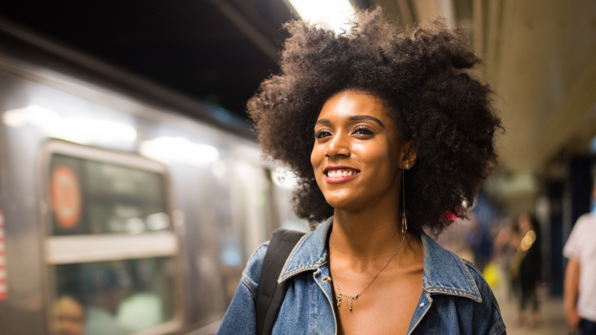 Happy and beautiful african american woman smiling. Pretty young female walking and having fun in New York city.