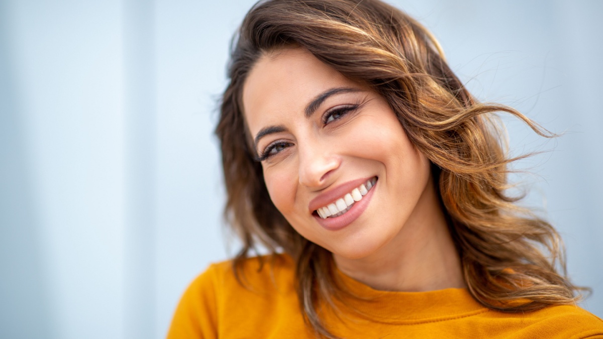 Close up face portrait smiling young woman.