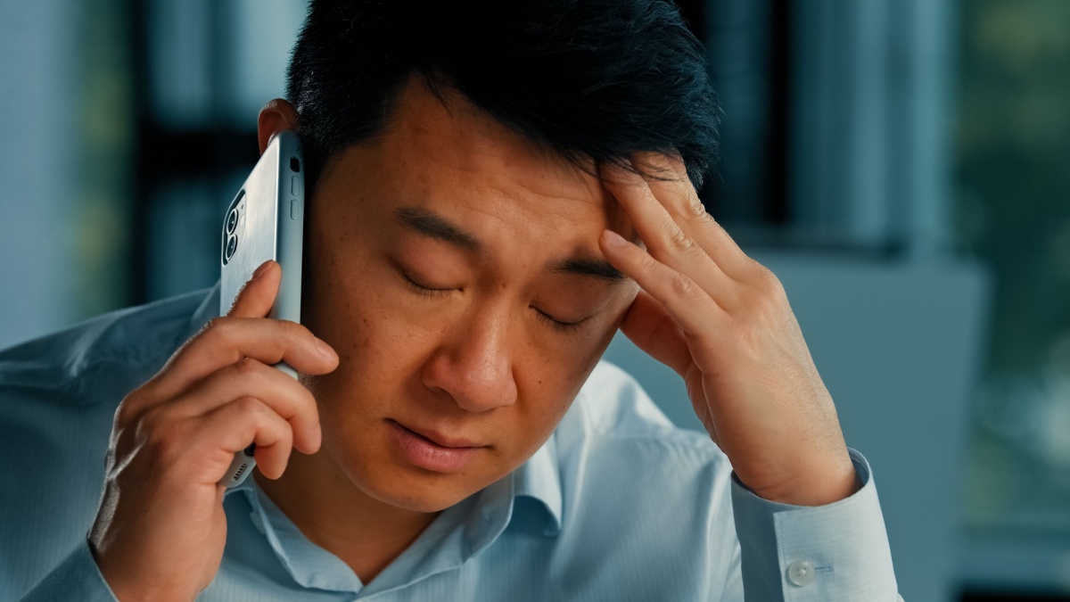Dissatisfied male businessman client annoyed asian korean angry man talking mobile phone has misunderstanding problem complaints with client solve business conflict by smartphone bad cell connection.