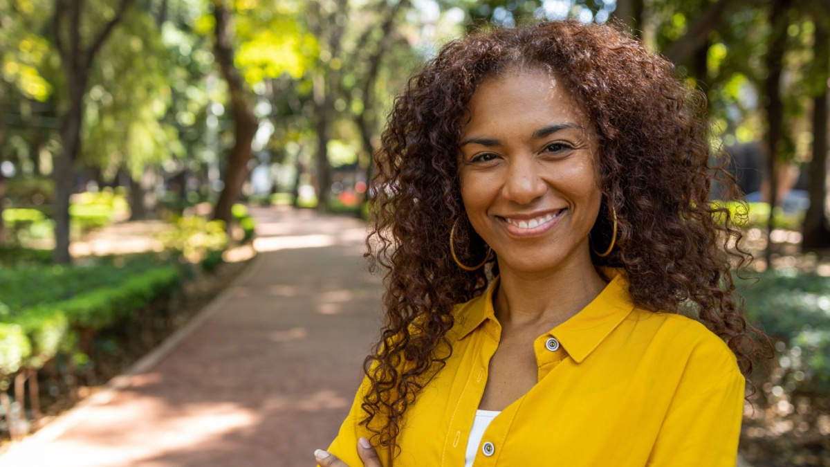 Portrait of smiling Brazilian woman looking at the camera.