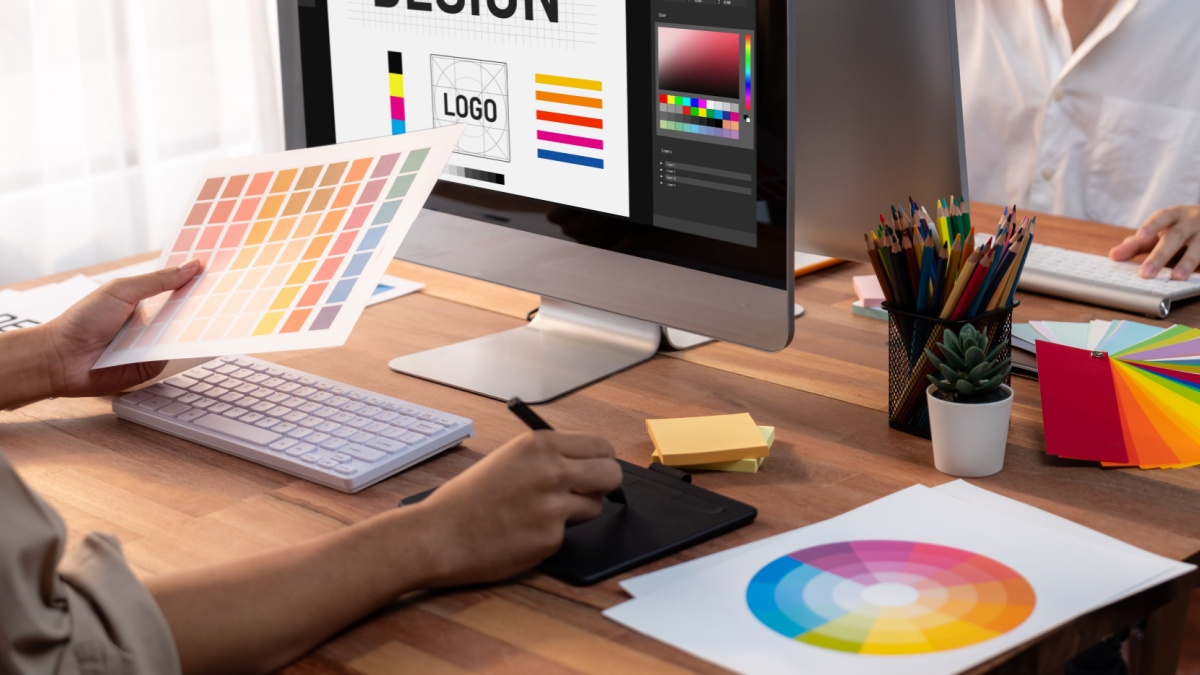 Graphic designer work on computer laptop and with graphic drawing pen while brainstorming unique design with professional graphic team in modern digital studio workplace. 