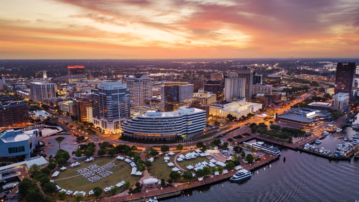 Norfolk, Virginia, USA downtown city skyline from over the Elizabeth River at dusk.
