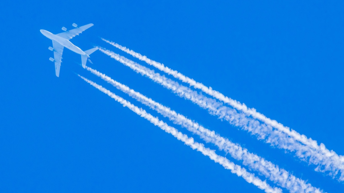Super heavy commercial aircraft with massive contrails flying over Germany