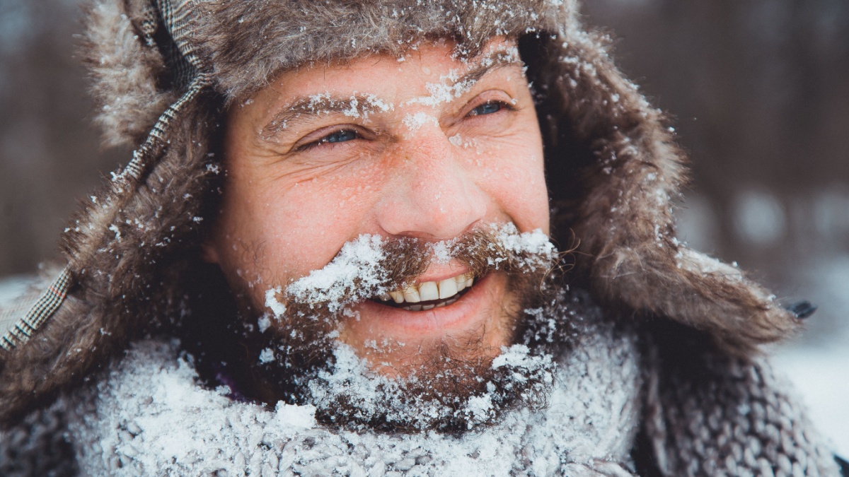Portrait of a young handsome man with a beard. A person close-up of a bearded man. Face full face bearded. A man with a beard winter.