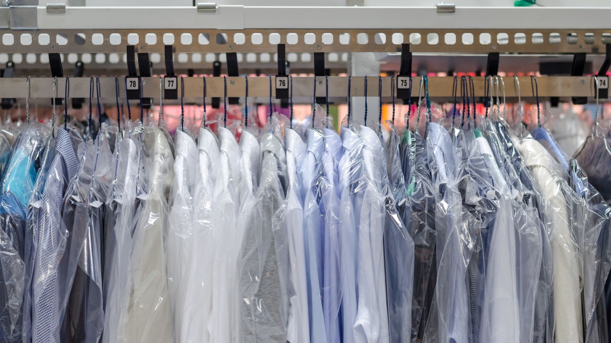 Clean clothes on hangers in the laundry room