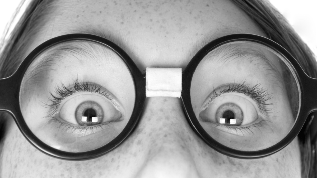young nerd child with freckles and glasses.