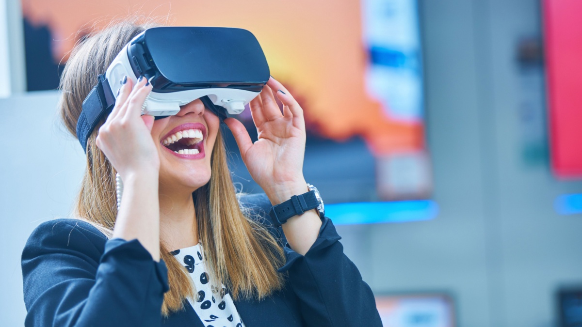 Young woman wearing virtual reality device.